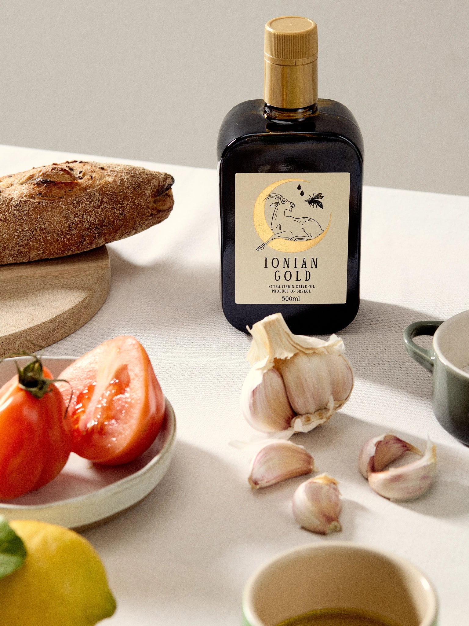 Ionian Gold 'Gold Cap' olive oil with foods.